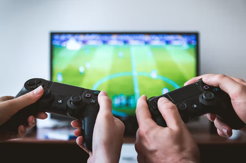 Two people playing a video game as an example of identifying your Tiktok’s target audience’s interests.