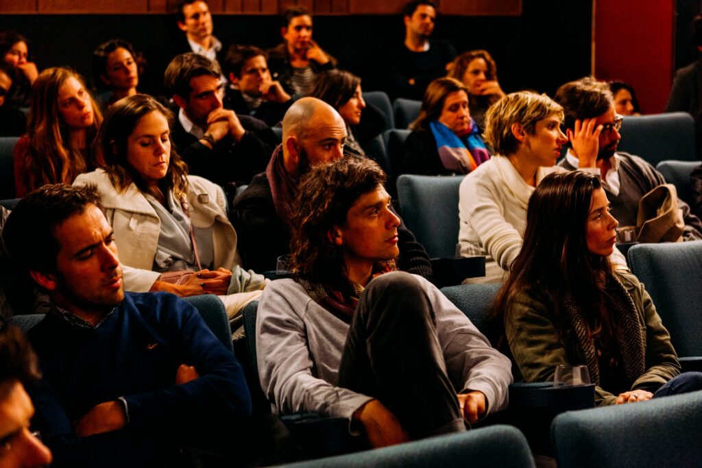 An audience listening to a speaker.