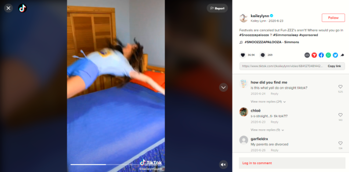 A woman diving backward into her bed.