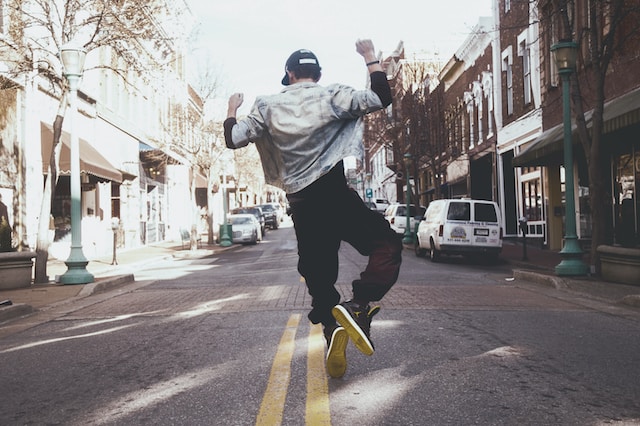 A man dancing in the middle of a street.