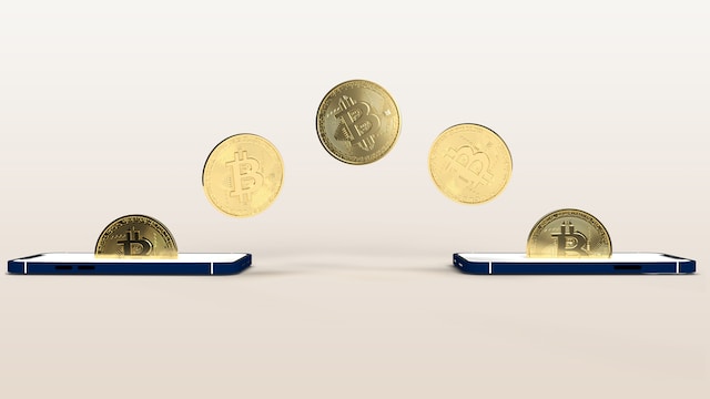 Two smartphones exchanging coins.