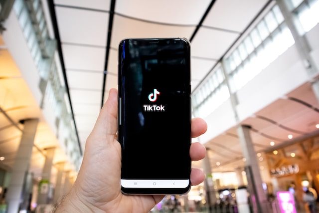 Phone screen displaying the TikTok logo.