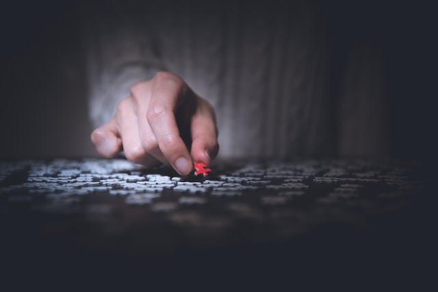 A person solving a jigsaw puzzle.