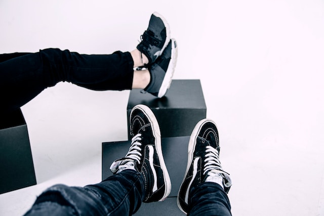 Two people showing off their new sneakers.