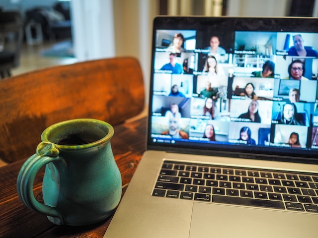 A laptop screen displaying participants in a live stream.