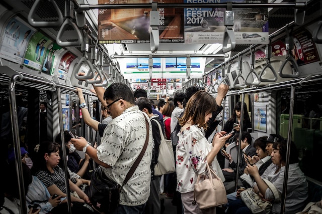 People on a train watching videos on their smartphones.