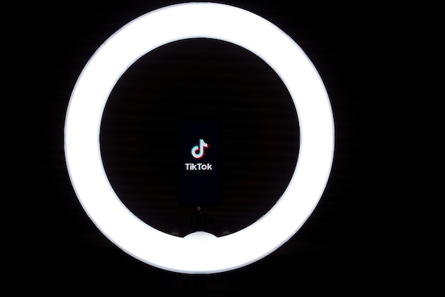 TikTok logo and name in the middle of a ring light.