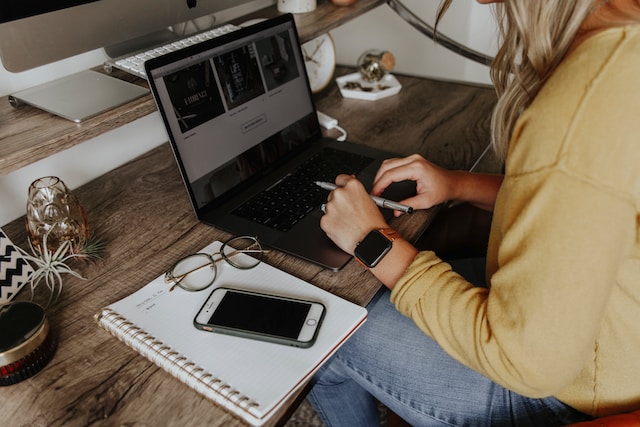 A woman working on an ad campaign on her laptop.