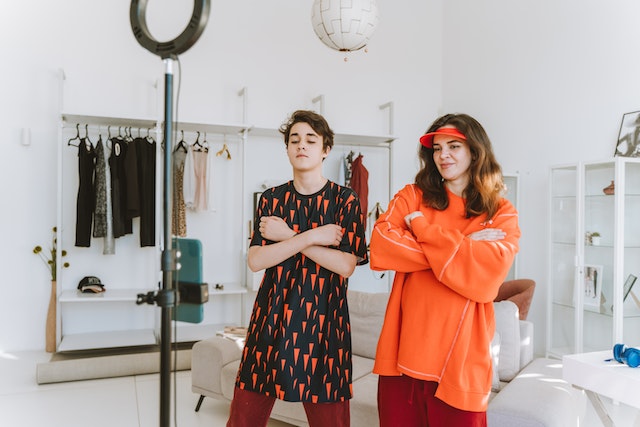 A woman and man recording a TikTok video together.