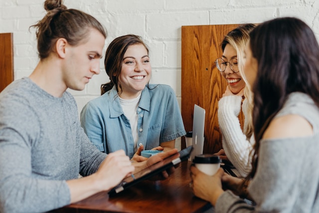 A group of young professionals having a casual meeting over coffee.