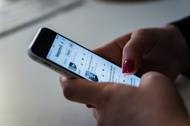 A person reading social media comments on their phone.