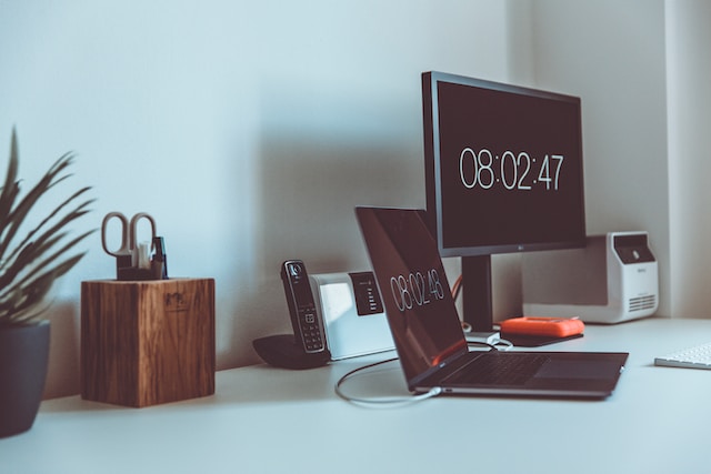Two computer screens showing a timer counting down.
