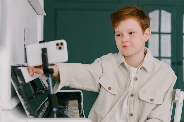 A young boy editing his video before sharing it on the TikTok platform.