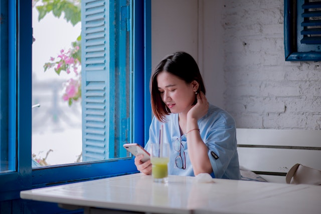 A user contemplating which TikTok automation feature to employ for her videos.