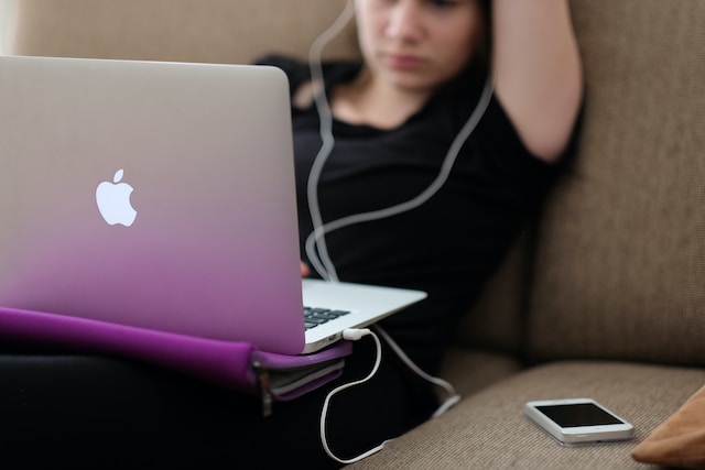 A girl is watching videos on her laptop.