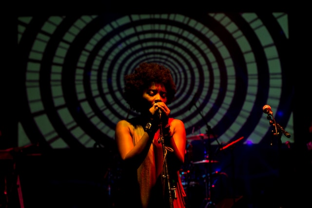 A woman singing for an audience.