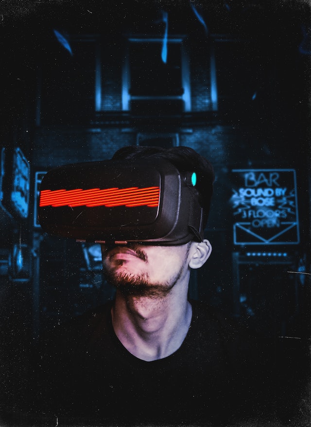 A man wearing VR goggles and gaming.