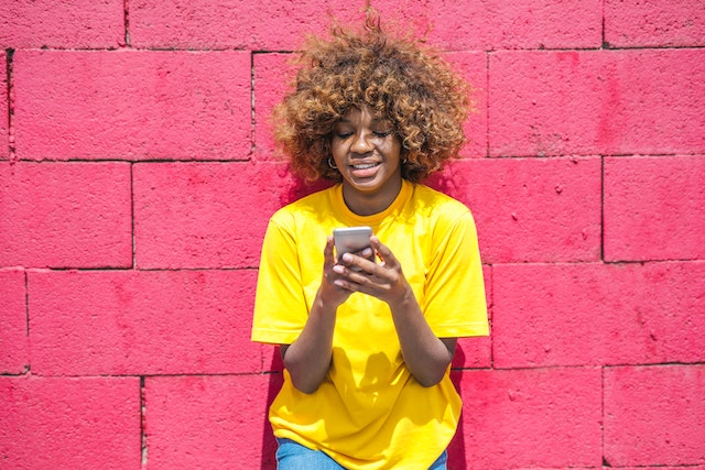 A female TikTok influencer searching for the best app to get TikTok followers for free.