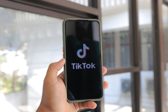 A person waits for the TikTok app to open on their phone.