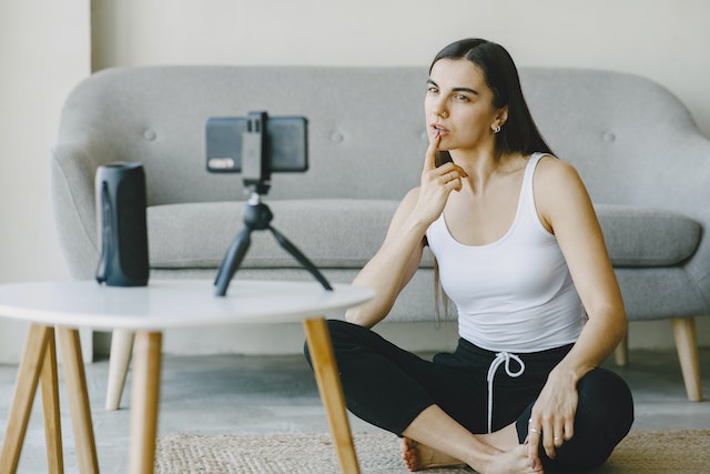 A girl posing for a video for TikTok.