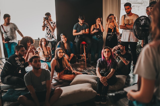 An audience attentively listens to a speaker.