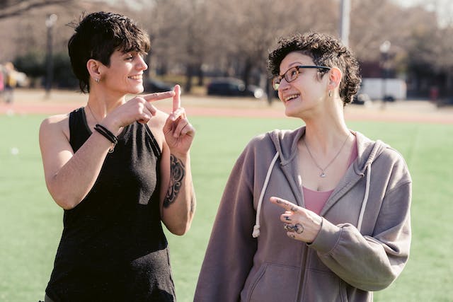 Two people communicating in sign language.
