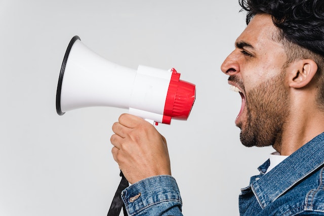 A man shouts into a megaphone.