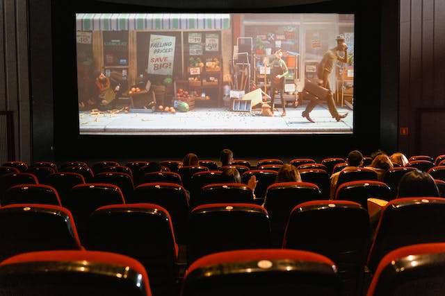 People watch a cartoon movie in a theater.