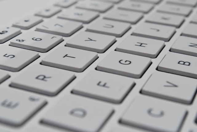 A closeup picture of a computer device’s white keyboard.
