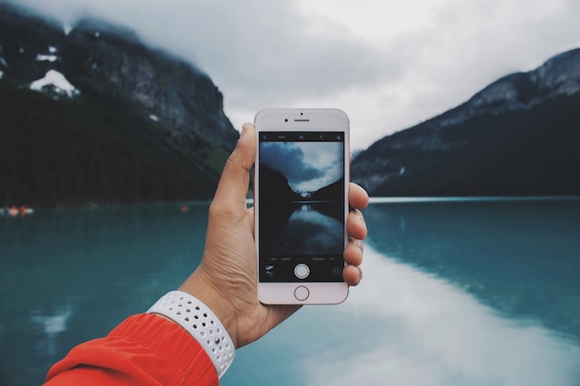 A TikTok creator holding a phone shooting a video of their travels.