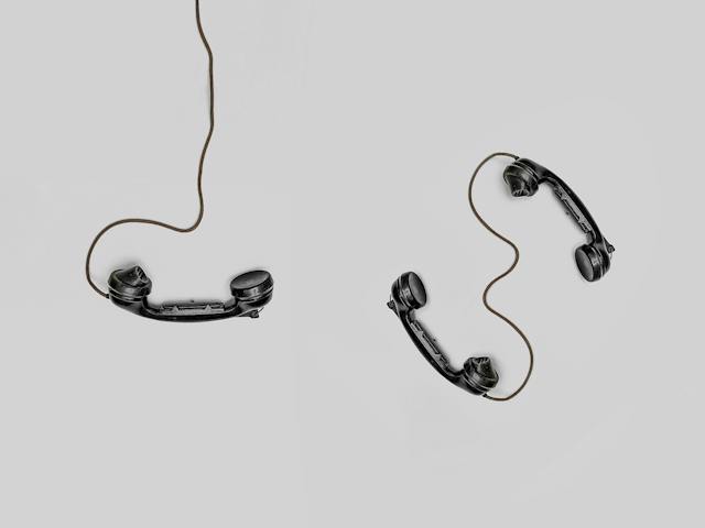 A photo of three analog phone handsets.