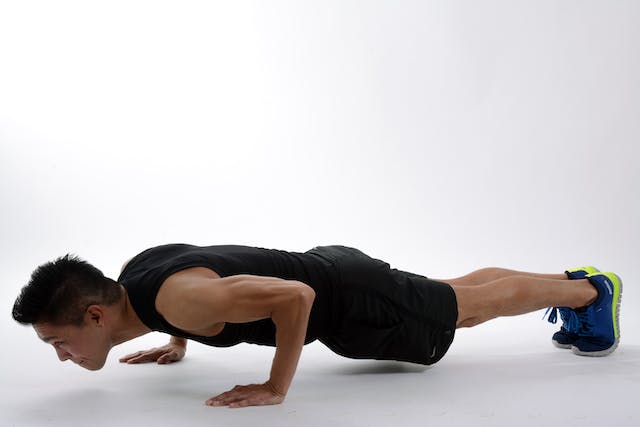 A photo of a man doing push-ups.
