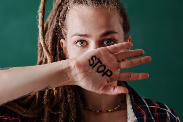 A woman covers her mouth with her hand.