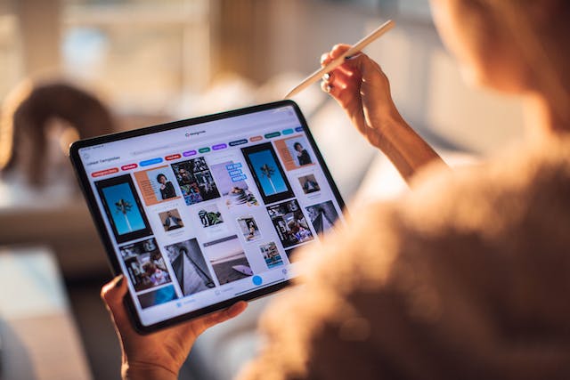 A person works on digital ads on their tablet.