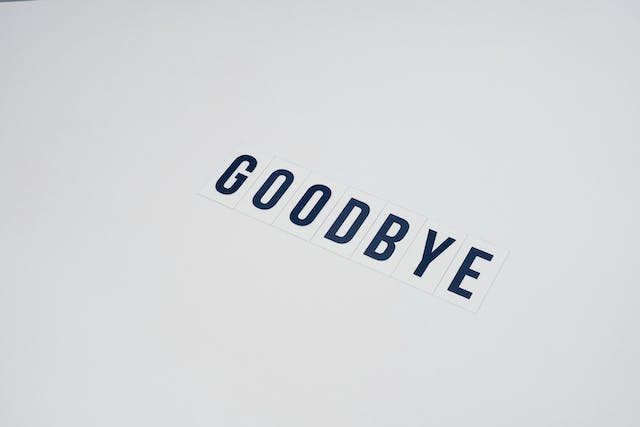 Paper cutouts spell the word “GOODBYE.”