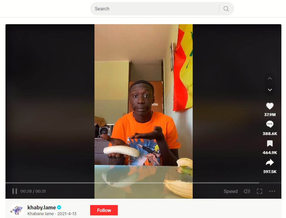 A TikTok screenshot of a man holding a peeled banana.
