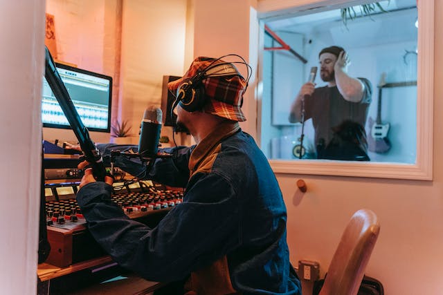 A photo of two men in a recording studio.