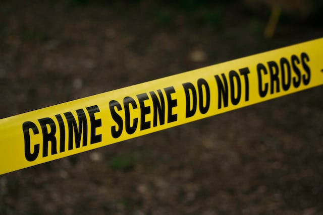 An image of yellow police tape with the words “CRIME SCENE DO NOT CROSS” printed on it.