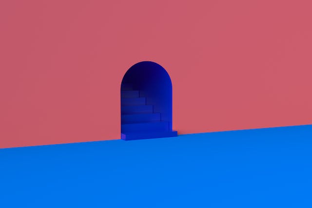 A high-contrast graphic shows an orange wall, a dark blue staircase, and a light blue floor.