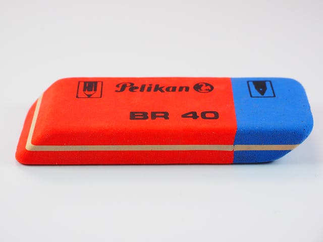 A photo of a red and blue rubber eraser.