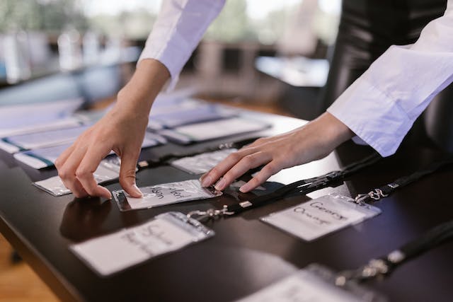 An image of a person sorting name tags.