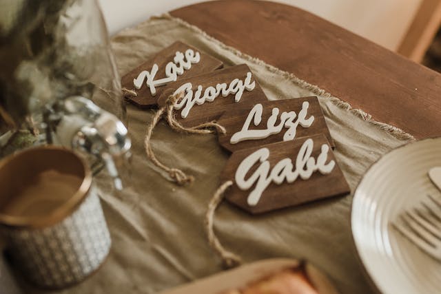 Wooden name tags sit on a table.