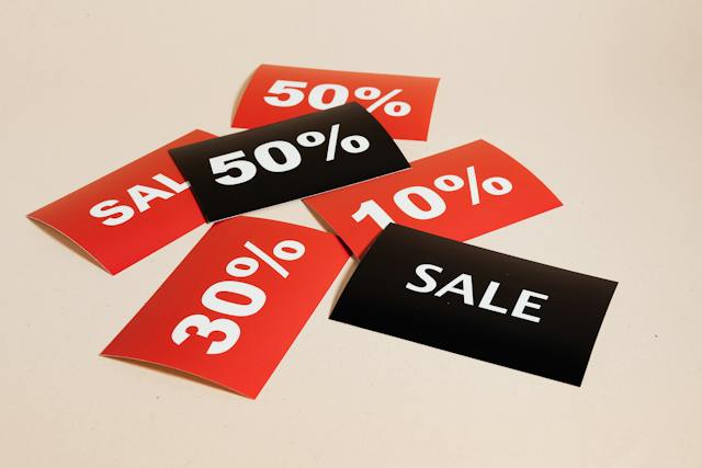 Red and black cards announce sales and discounts.