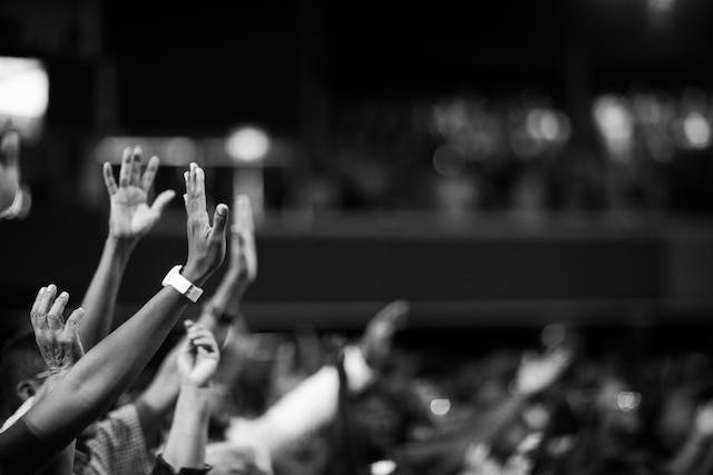 An image of people raising their hands.