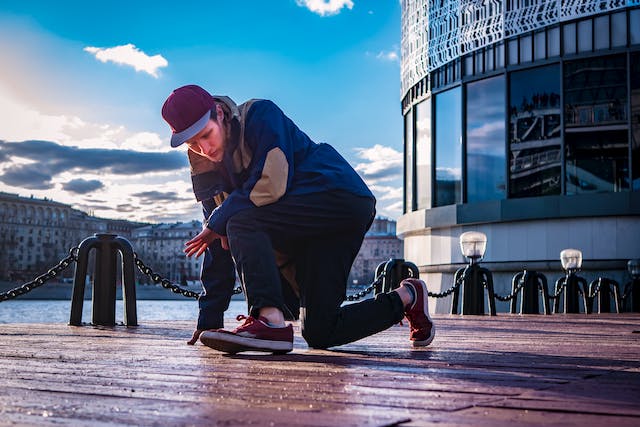A photo of a person breakdancing on a bridge.