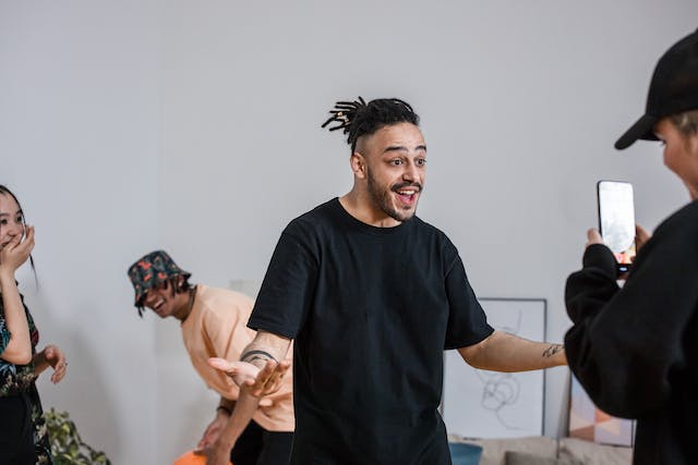 A group of people are having fun while using a phone to record a video.