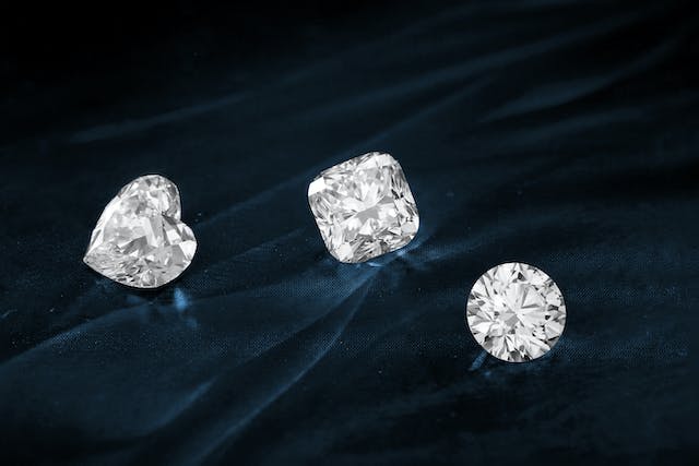 An image of three cut diamonds on top of a fabric.