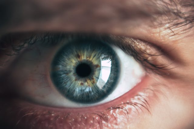 A close-up of a green and view human eye to symbolize TikTok views.