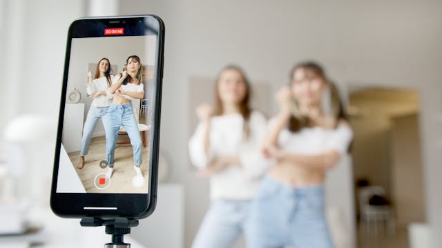 Two women film themselves taking part in a viral TikTok dance challenge.