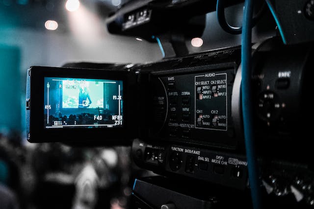 A black camera films a video.